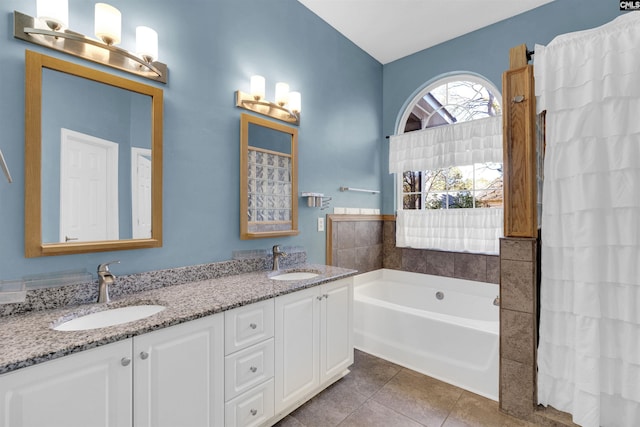 bathroom featuring a washtub, vanity, and tile patterned flooring