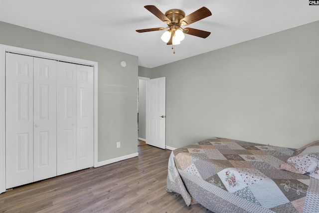 bedroom with hardwood / wood-style floors, a closet, and ceiling fan