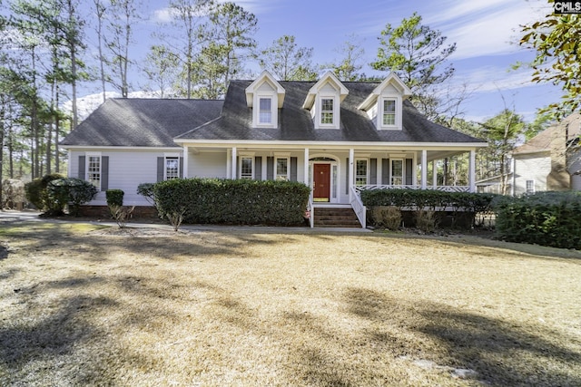 new england style home featuring a porch