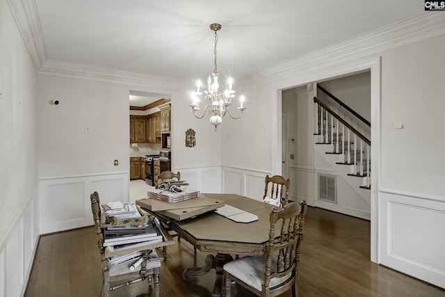 dining room with dark hardwood / wood-style flooring, ornamental molding, and a notable chandelier