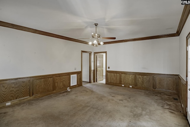 empty room featuring light colored carpet, ceiling fan, and crown molding