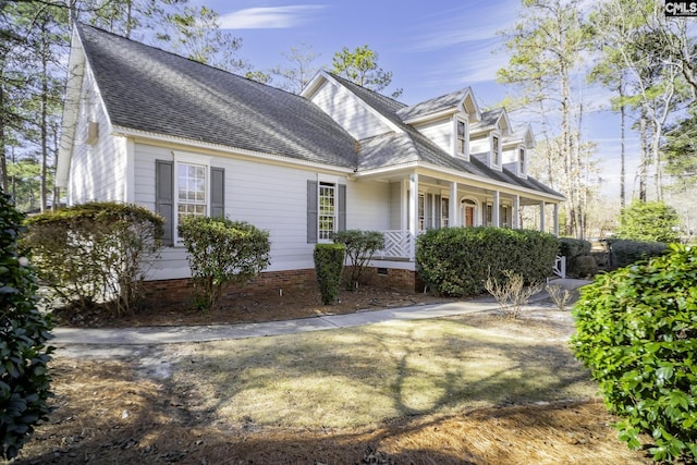 new england style home featuring covered porch