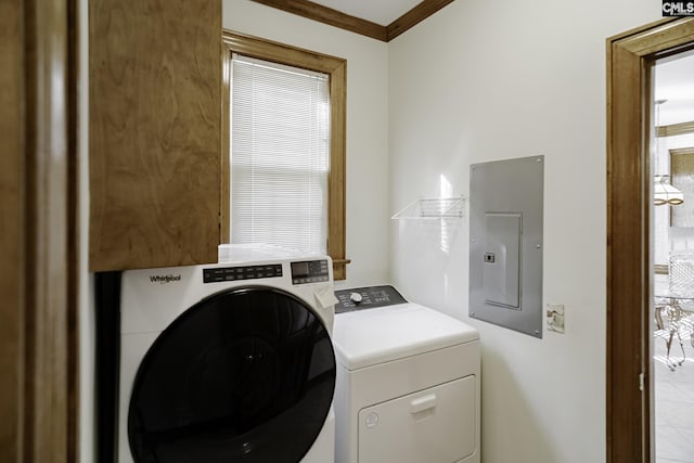 washroom with washing machine and dryer, ornamental molding, and electric panel