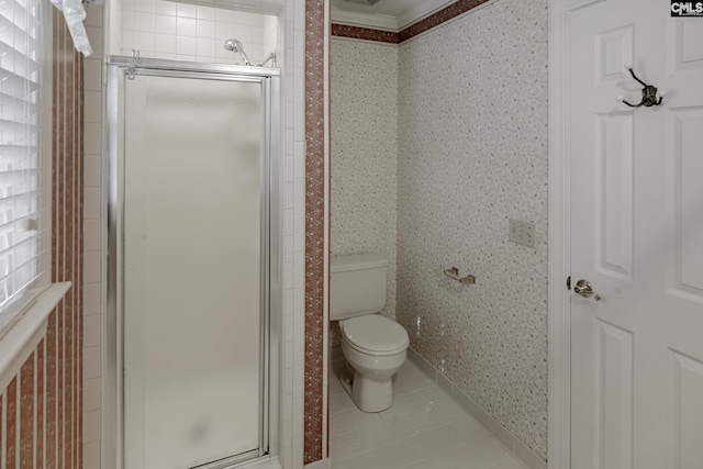 bathroom with ornamental molding, tile patterned flooring, a shower with shower door, and toilet