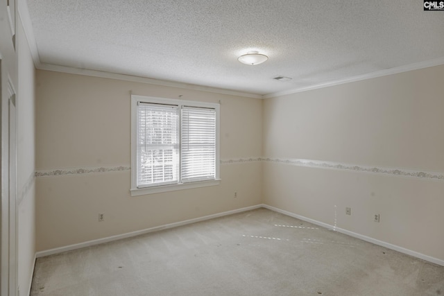 spare room featuring light carpet, a textured ceiling, and ornamental molding