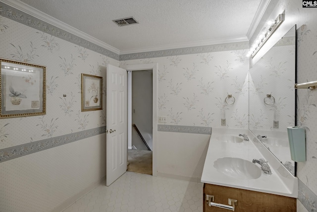 bathroom featuring tile patterned flooring, vanity, ornamental molding, and a textured ceiling