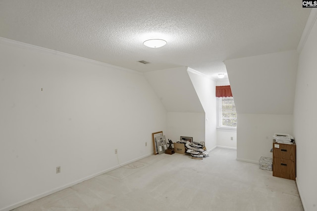 additional living space with a textured ceiling, light colored carpet, and lofted ceiling