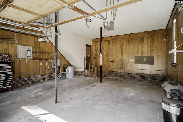 garage featuring wood walls and a garage door opener