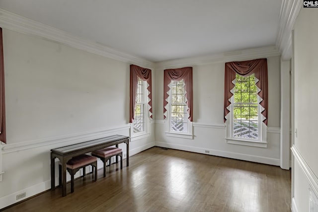 unfurnished room featuring crown molding and wood-type flooring