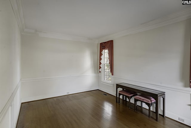 spare room with dark hardwood / wood-style flooring and ornamental molding