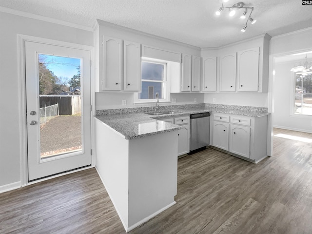 kitchen with white cabinets, a textured ceiling, stainless steel dishwasher, and sink