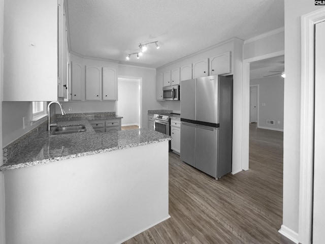 kitchen featuring white cabinetry, sink, a textured ceiling, and appliances with stainless steel finishes