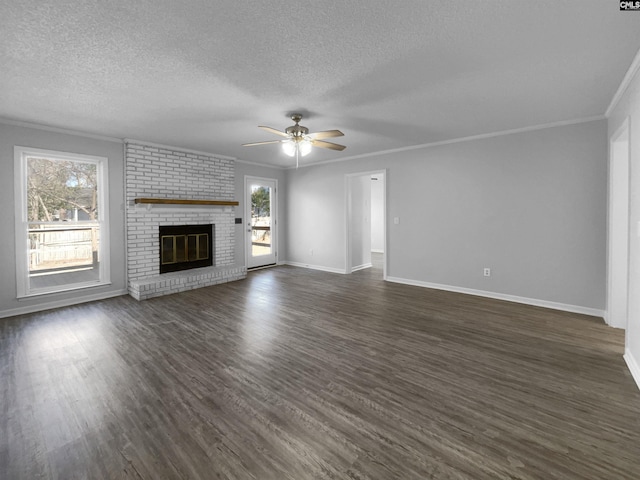 unfurnished living room with a fireplace, dark hardwood / wood-style flooring, ceiling fan, and crown molding