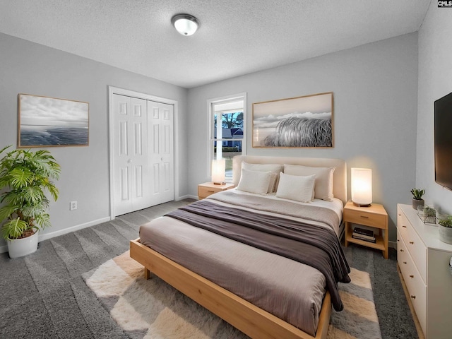 bedroom featuring a closet, dark carpet, and a textured ceiling