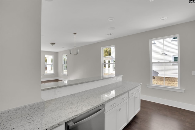 kitchen featuring light stone countertops, stainless steel dishwasher, a healthy amount of sunlight, decorative light fixtures, and white cabinets