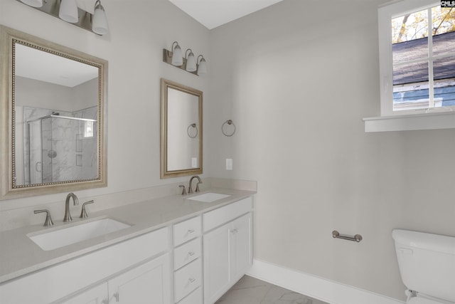 bathroom with an enclosed shower, vanity, toilet, and plenty of natural light