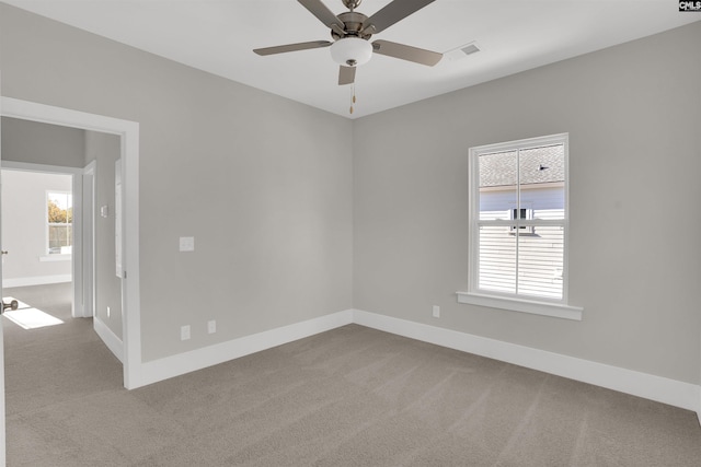 empty room featuring carpet and ceiling fan