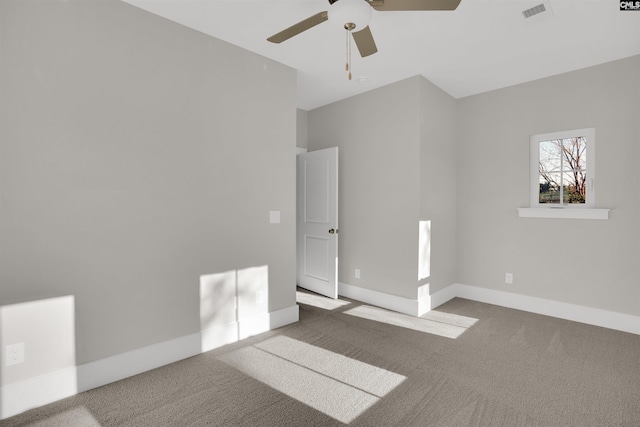 carpeted spare room with ceiling fan