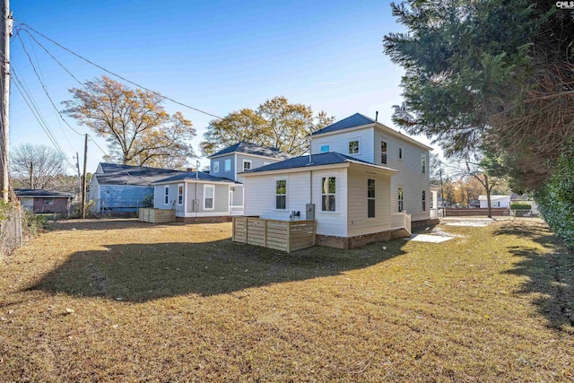 rear view of property with a yard