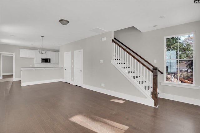 unfurnished living room featuring dark wood-type flooring