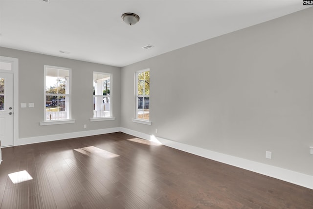 empty room with dark hardwood / wood-style flooring