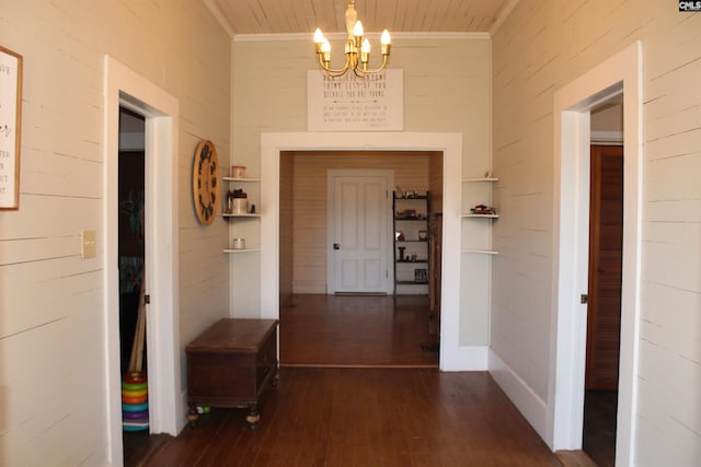 hallway with dark hardwood / wood-style flooring, wooden ceiling, and a notable chandelier