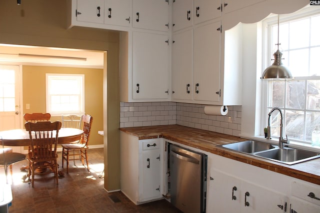 kitchen featuring dishwasher, wood counters, sink, decorative backsplash, and white cabinetry