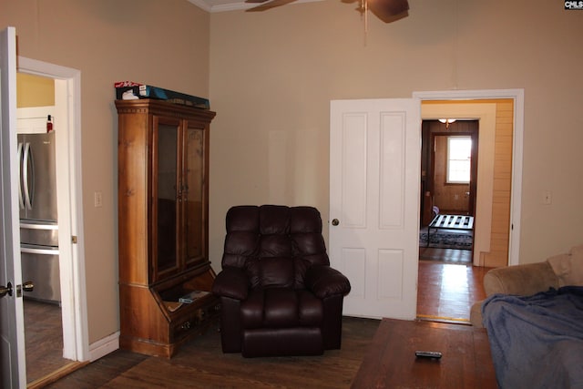 sitting room featuring ceiling fan, dark hardwood / wood-style flooring, and crown molding