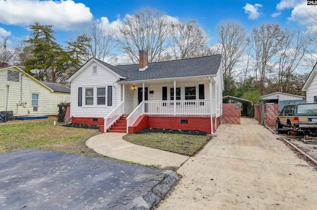 bungalow-style house featuring cooling unit, a porch, and a front lawn