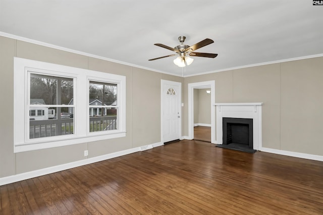 unfurnished living room with crown molding, ceiling fan, and dark hardwood / wood-style floors