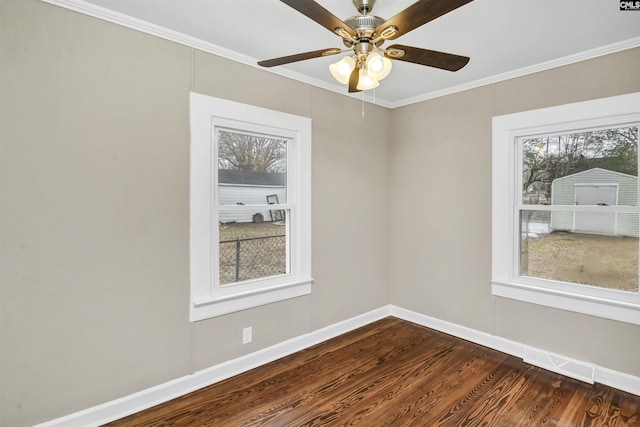 unfurnished room featuring dark hardwood / wood-style flooring, ceiling fan, and ornamental molding