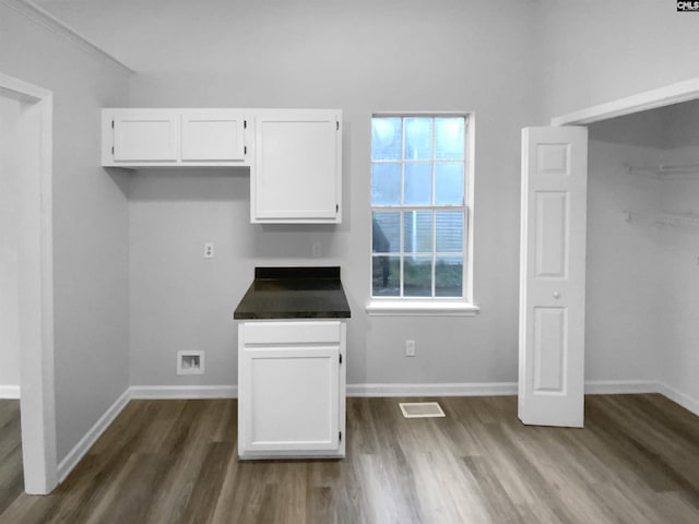 kitchen with white cabinetry and dark wood-type flooring