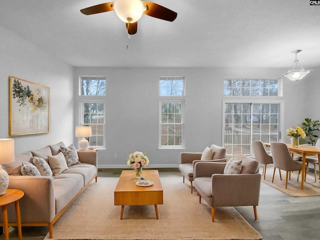 living room featuring a wealth of natural light, light hardwood / wood-style floors, and ceiling fan