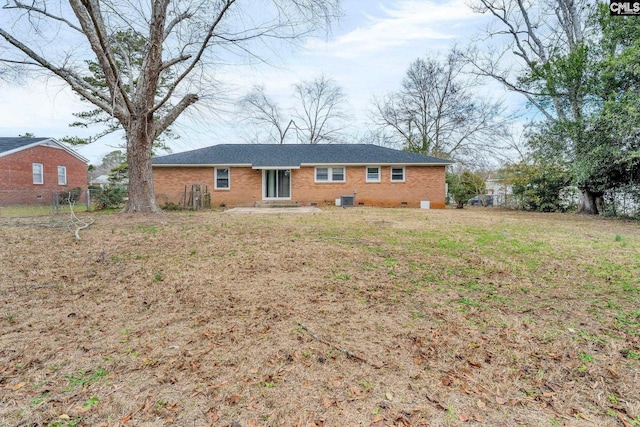 rear view of house featuring a yard and central AC