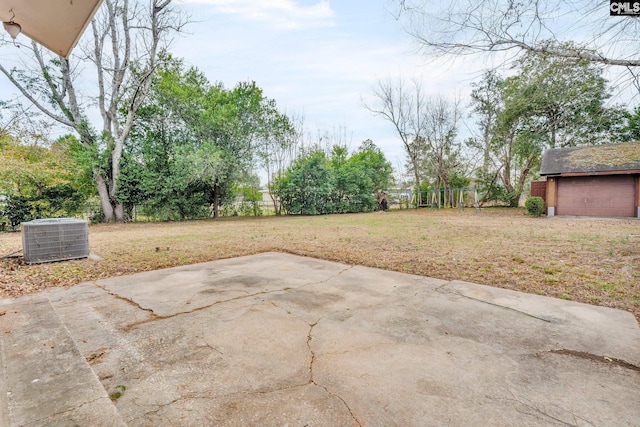 view of patio / terrace featuring a playground, an outbuilding, and central air condition unit