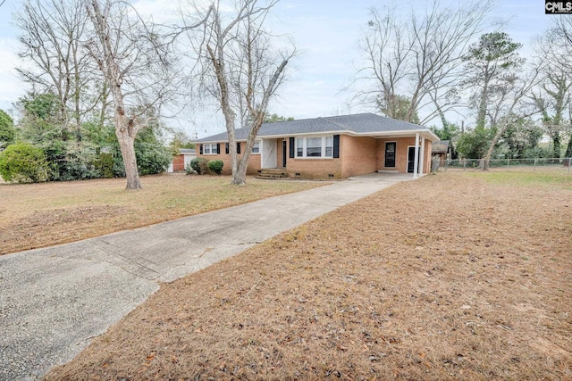 ranch-style house featuring a front yard and a carport