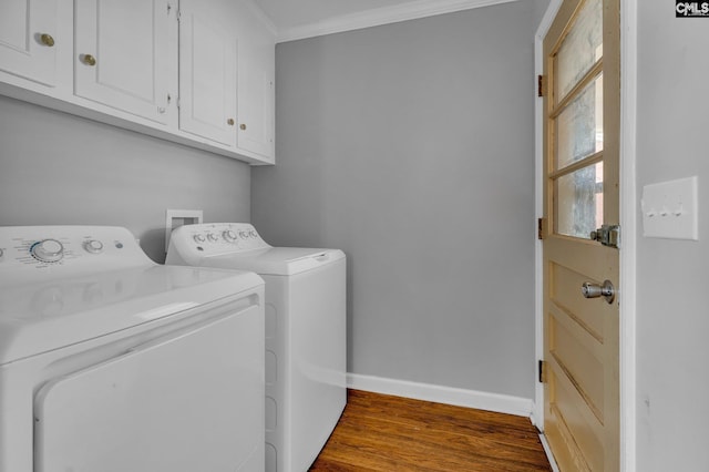 washroom featuring hardwood / wood-style floors, cabinets, separate washer and dryer, and crown molding