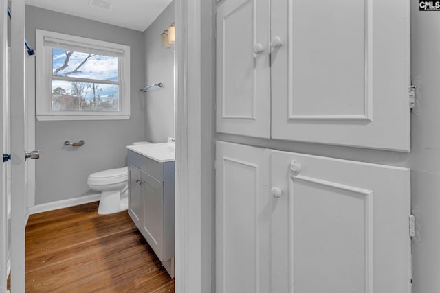 bathroom featuring hardwood / wood-style floors, vanity, and toilet