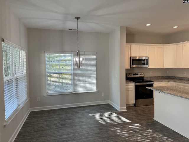 kitchen featuring light stone countertops, a chandelier, pendant lighting, white cabinets, and appliances with stainless steel finishes