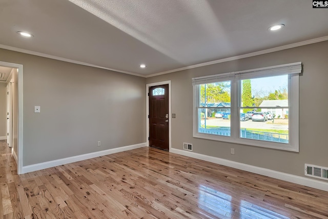 interior space featuring light hardwood / wood-style floors and crown molding