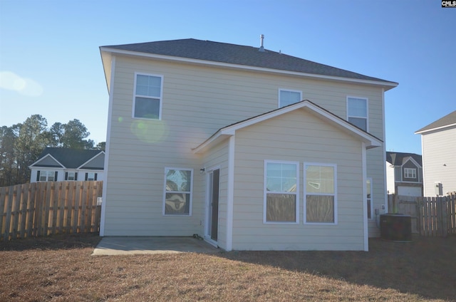 rear view of house featuring a patio and a lawn