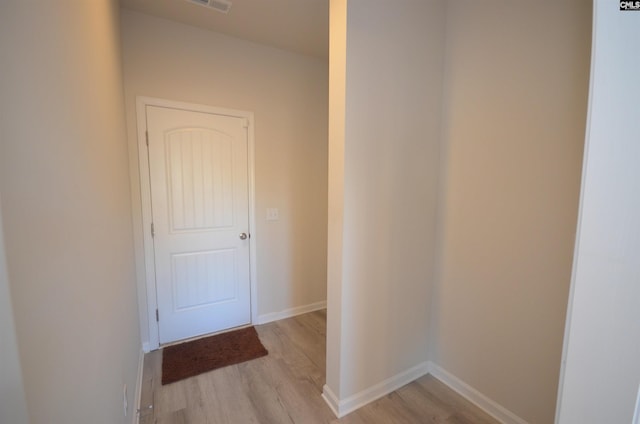 hallway with light hardwood / wood-style flooring