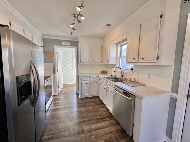 kitchen featuring crown molding, sink, appliances with stainless steel finishes, dark hardwood / wood-style flooring, and white cabinetry