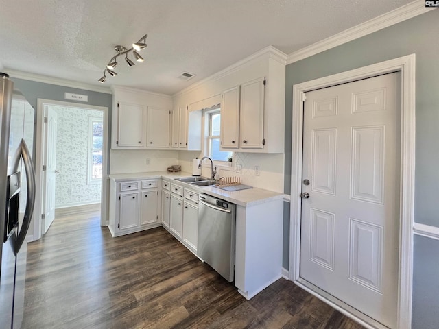 kitchen with sink, stainless steel appliances, dark hardwood / wood-style flooring, white cabinets, and ornamental molding