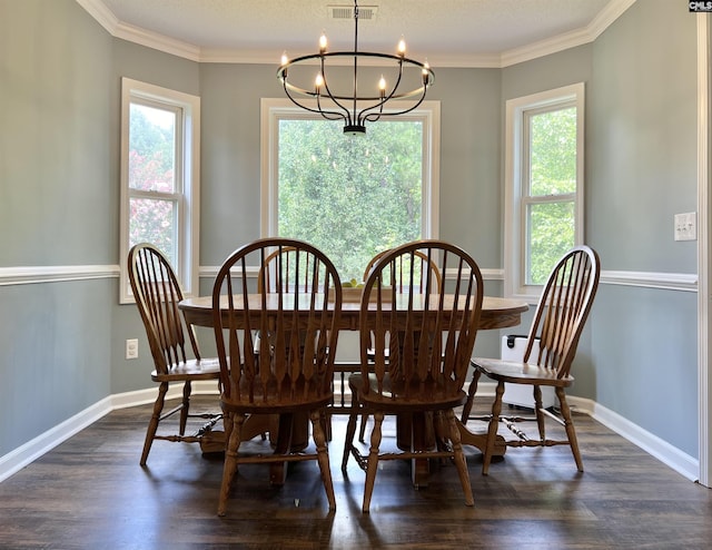 dining space featuring dark hardwood / wood-style flooring, an inviting chandelier, and ornamental molding