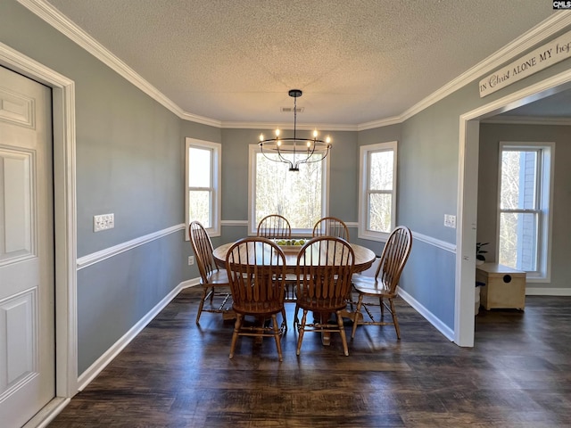 dining area with a textured ceiling, dark wood-type flooring, an inviting chandelier, and ornamental molding