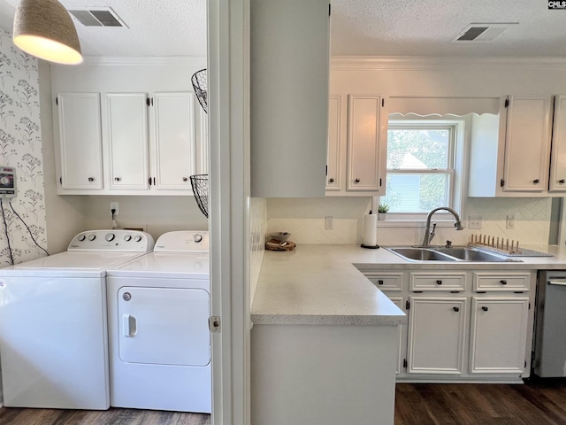 clothes washing area featuring independent washer and dryer, a textured ceiling, crown molding, and sink