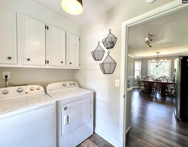 laundry area featuring crown molding, separate washer and dryer, a textured ceiling, dark hardwood / wood-style flooring, and a chandelier