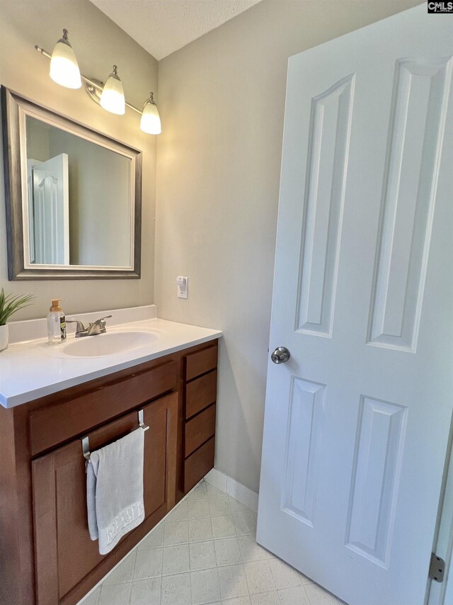 bathroom featuring vanity and a textured ceiling