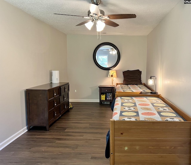 bedroom featuring a textured ceiling, dark hardwood / wood-style flooring, and ceiling fan